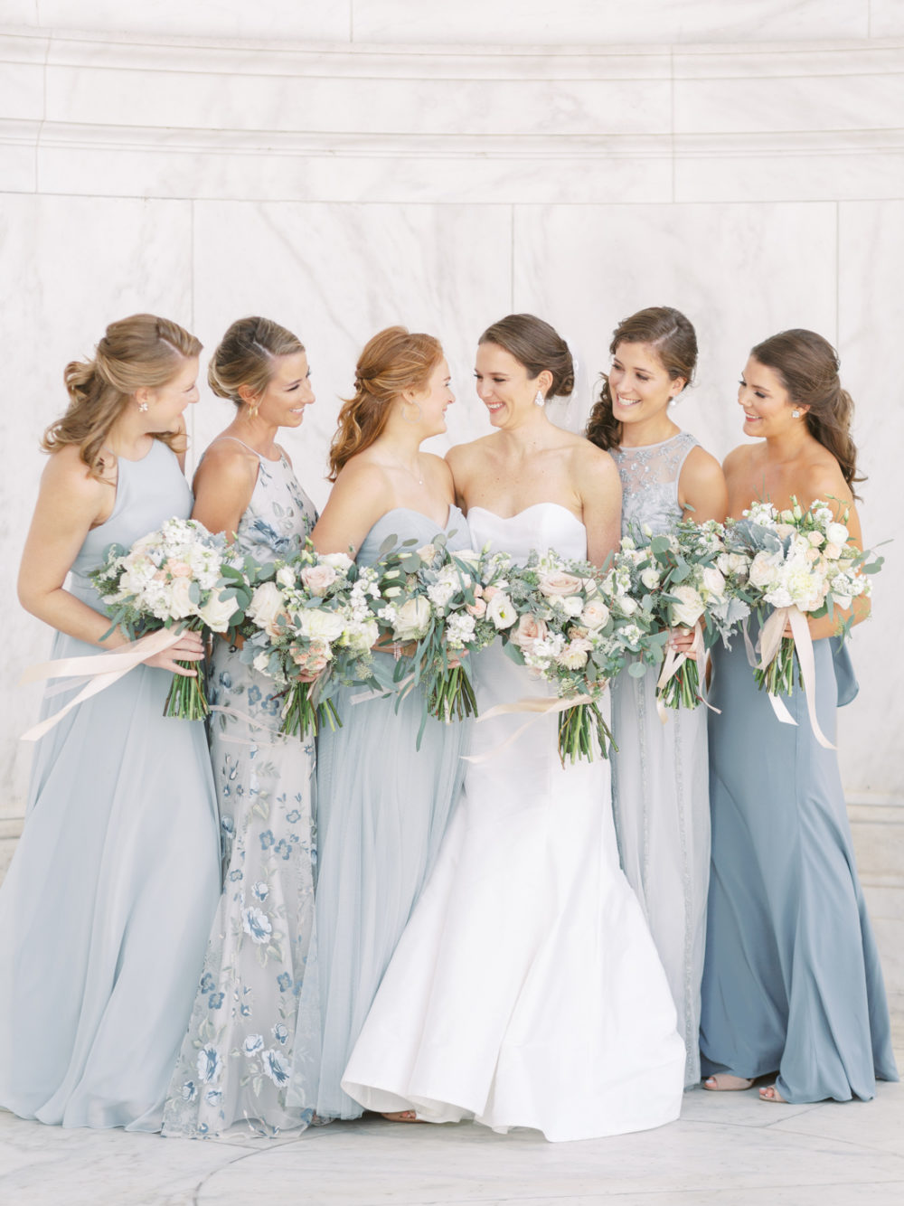 Dusty blue bridesmaids at the Jefferson Memorial for wedding pictures.