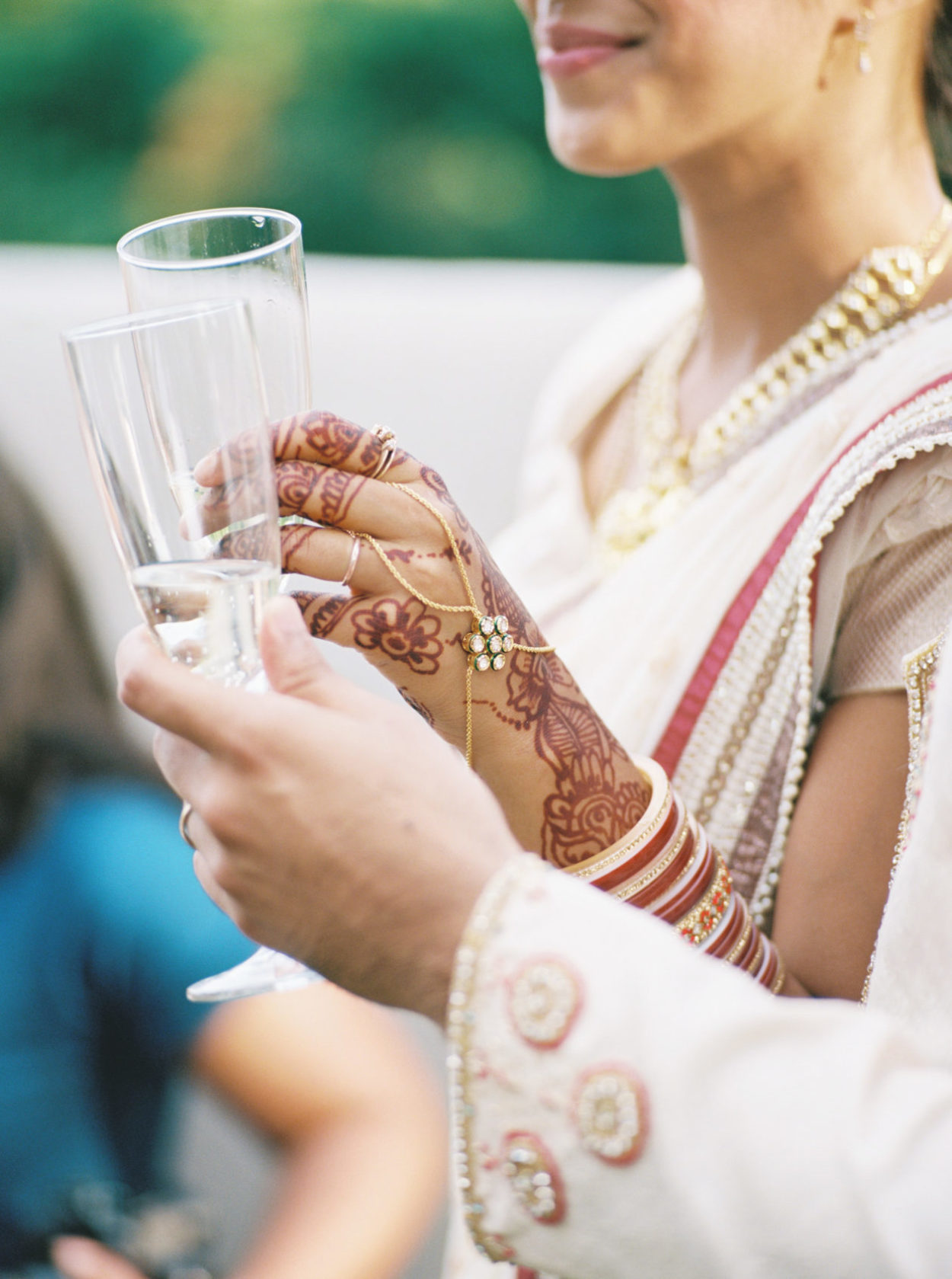 Modern mendhi and hand jewelry at fall Indian wedding reception
