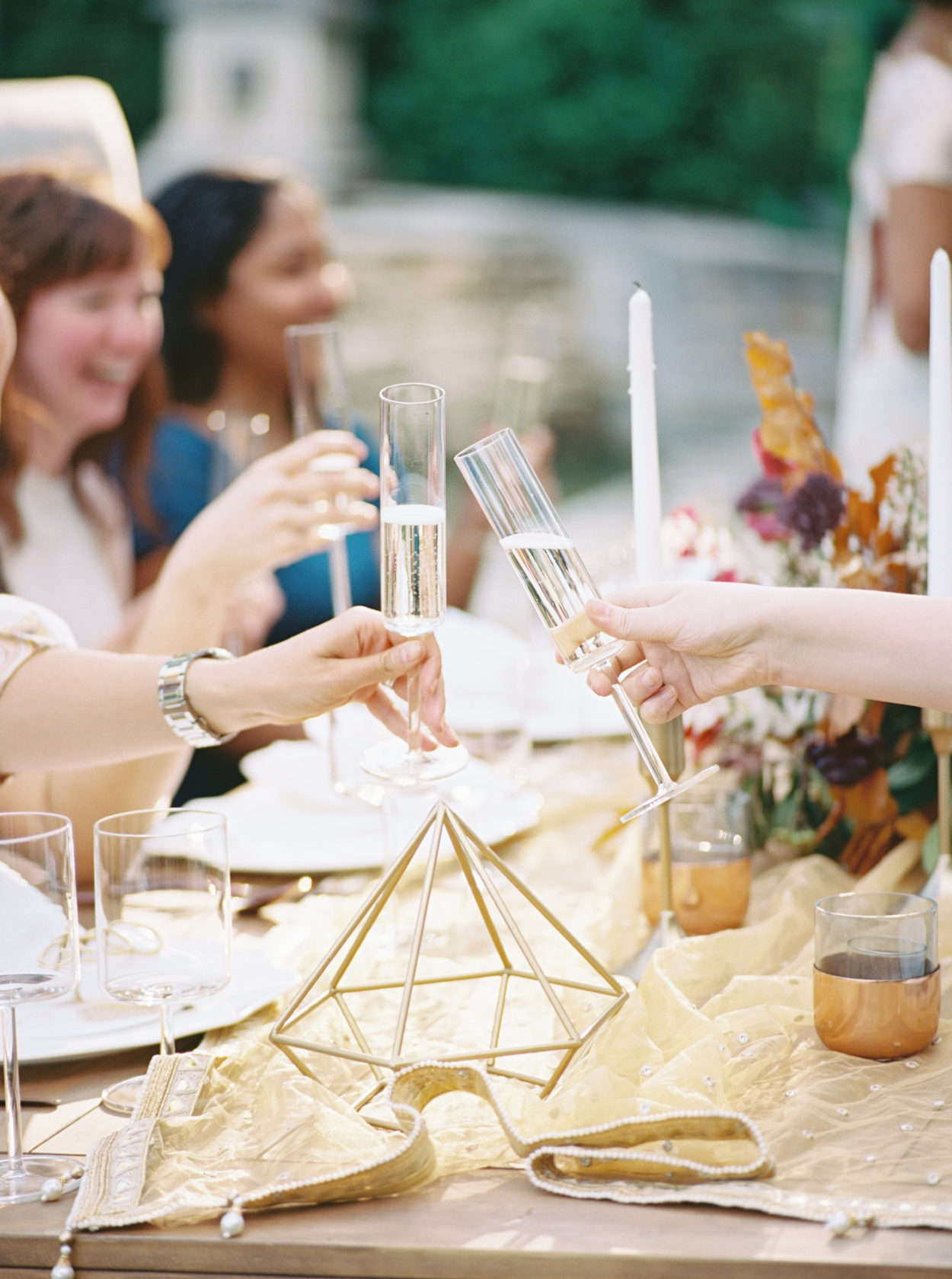 Guests toasting at modern outdoors al fresco wedding reception