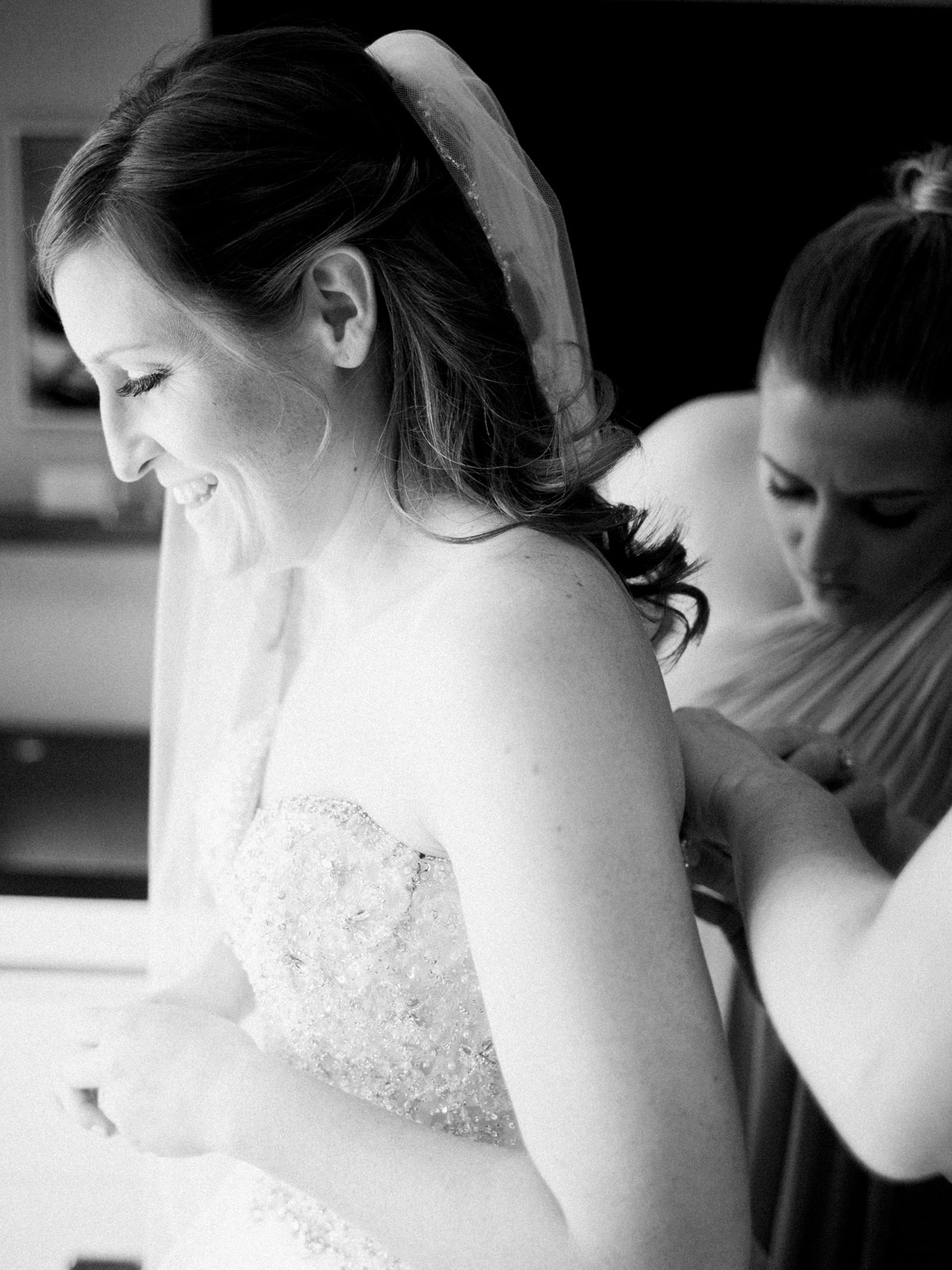Bride is excited about wedding day as she gets dressed