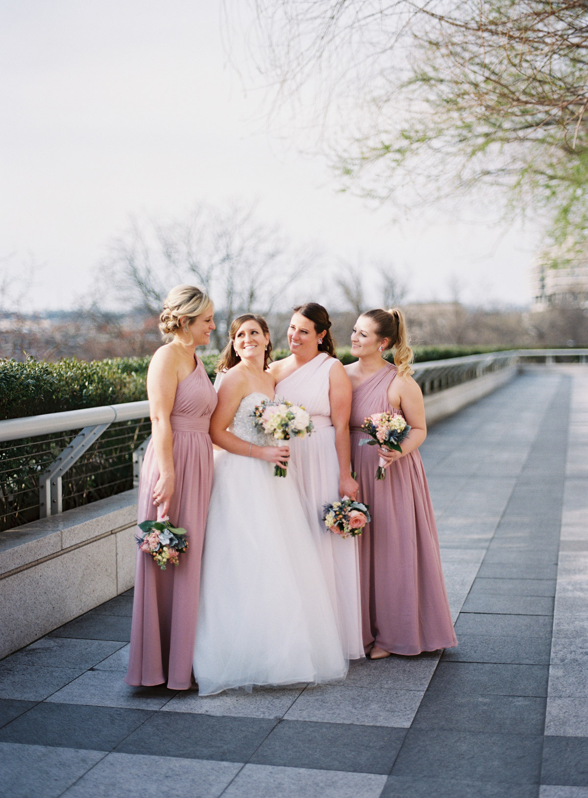 Pink bridesmaids posing at the Kennedy Center in Washington, DC