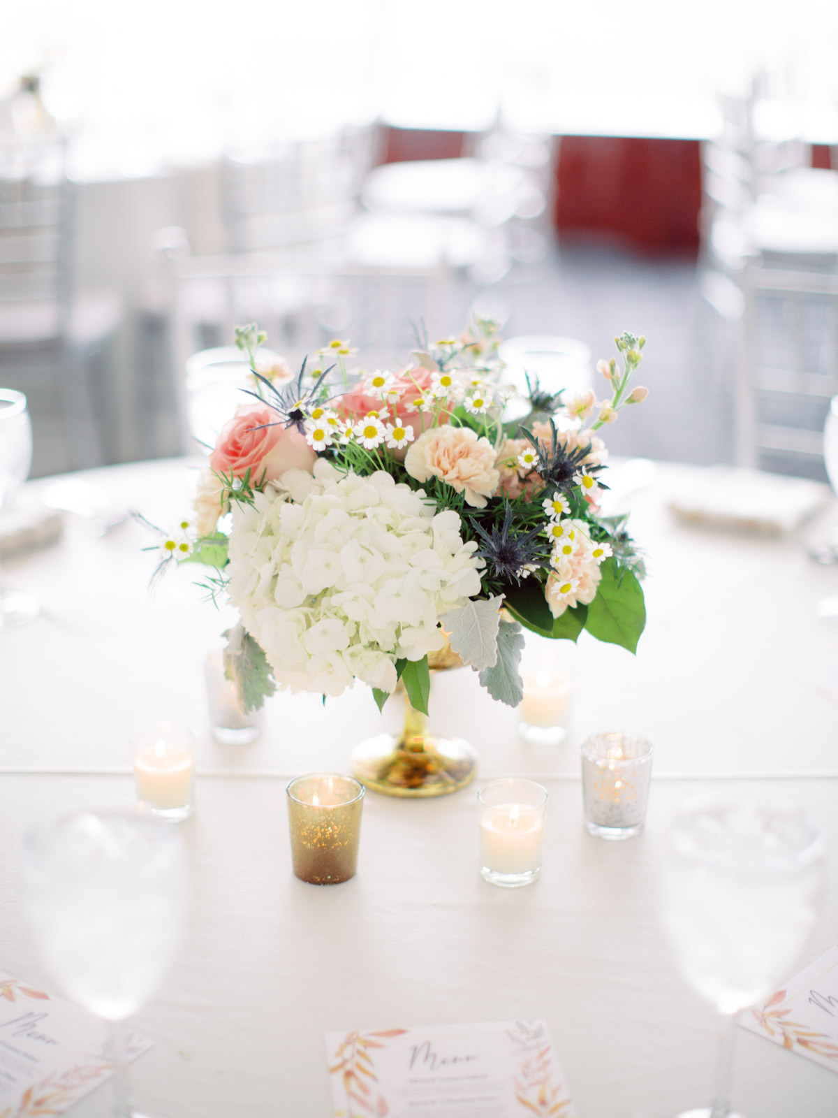 Floral table centerpieces at wedding reception at Top of the Town Arlington