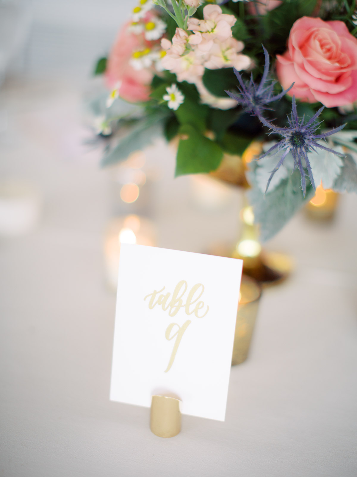 Calligraphy gold foil table numbers for wedding reception at Top of the Town Arlington