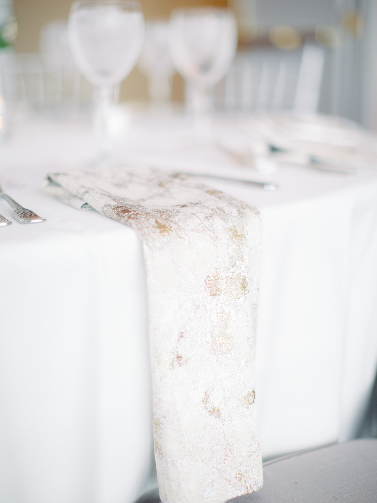 White and gold foil wedding reception table napkins at Top of the Town Arlington