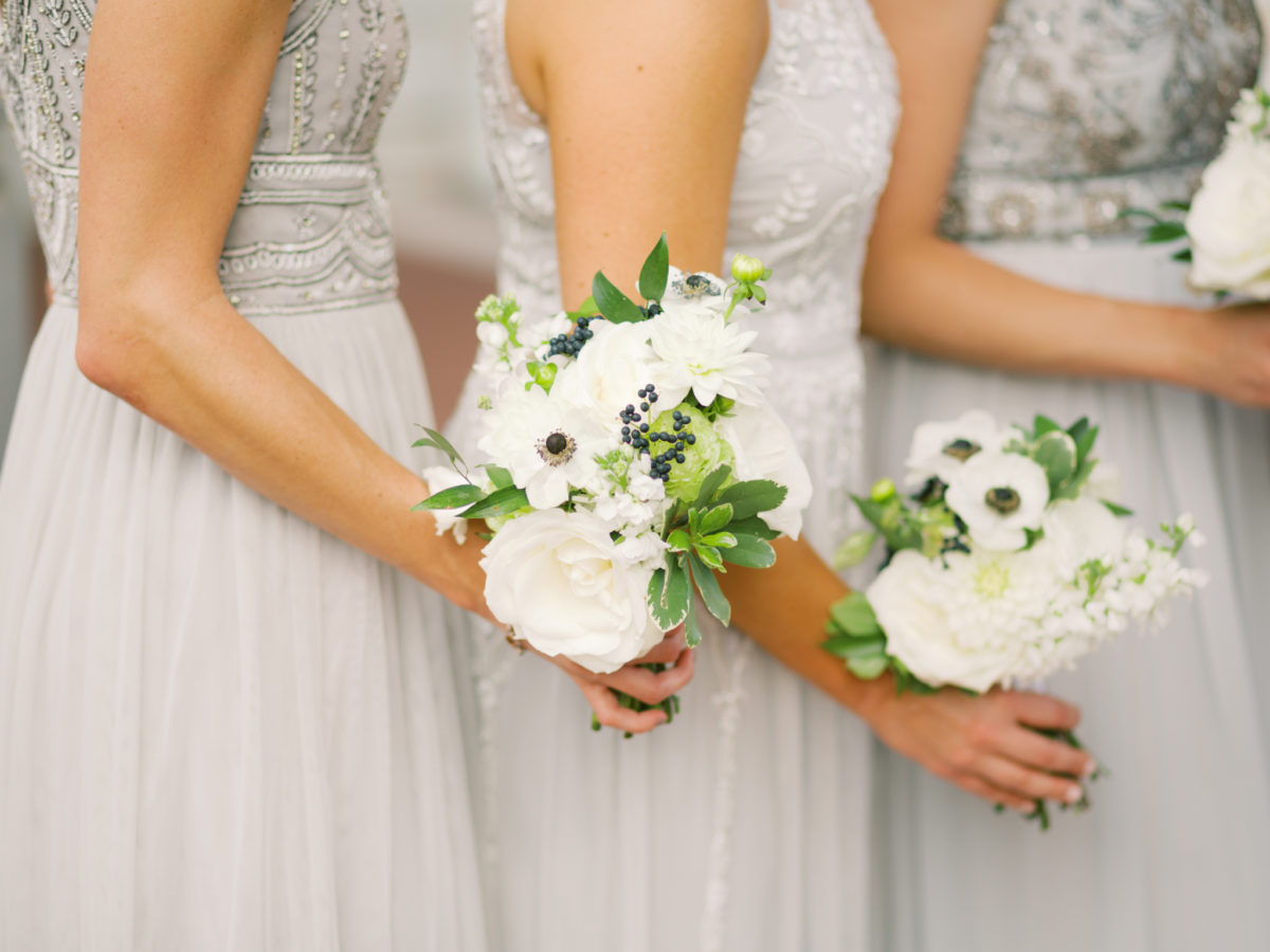 Gray bridesmaids dresses pose for pictures at the US Naval Academy in Annapolis, Maryland.