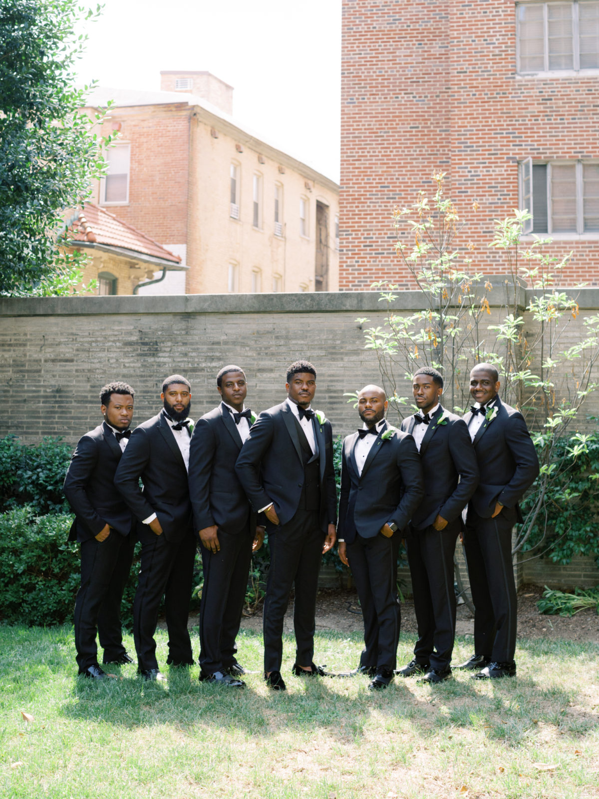 Groomsmen pose on the back lawn of Anderson House for wedding in DC.