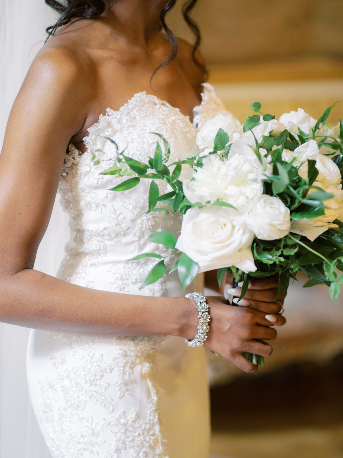 White roses wedding bouquet with greenery by Floral & Bloom.