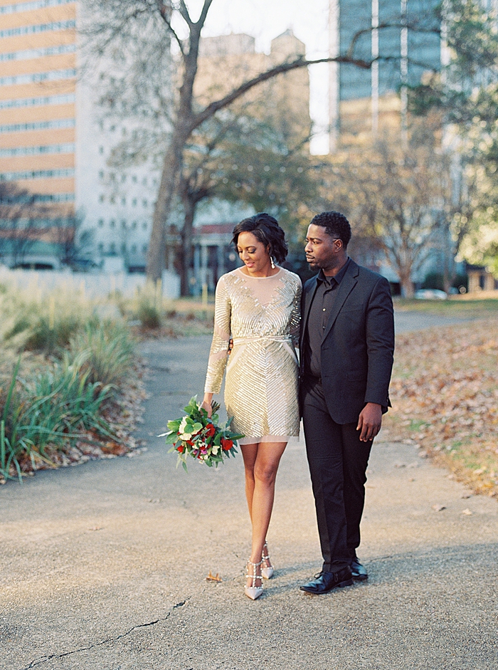 Chic downtown Jackson, MS engagement featuring a red roses bouquet.